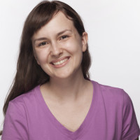 Portrait of smiling young woman in purple t-shirt, studio shot Portrait of smiling young woman in purple t-shirt, studio shot