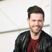 Stylish young man smiling outdoors Close up portrait of a stylish young man smiling outdoors